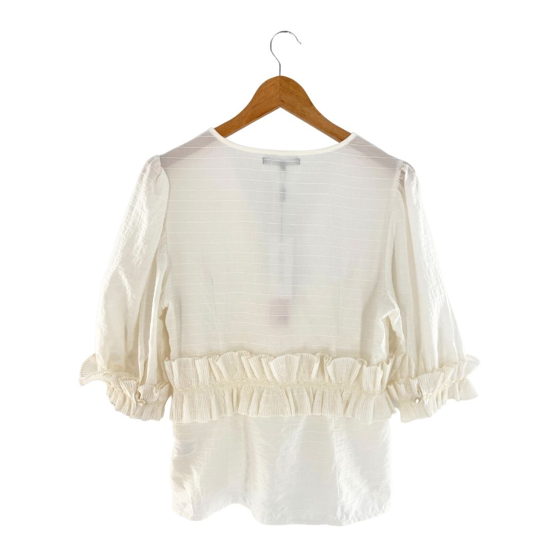 Blusa mangas amplias con vuelo