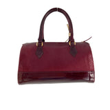 Cartera tipo baul con charol