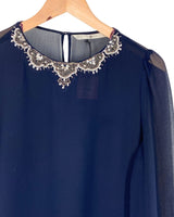 Blusa traslucida con recamado