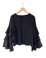 Blusa con vuelos en mangas