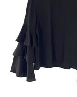 Blusa con vuelos en mangas